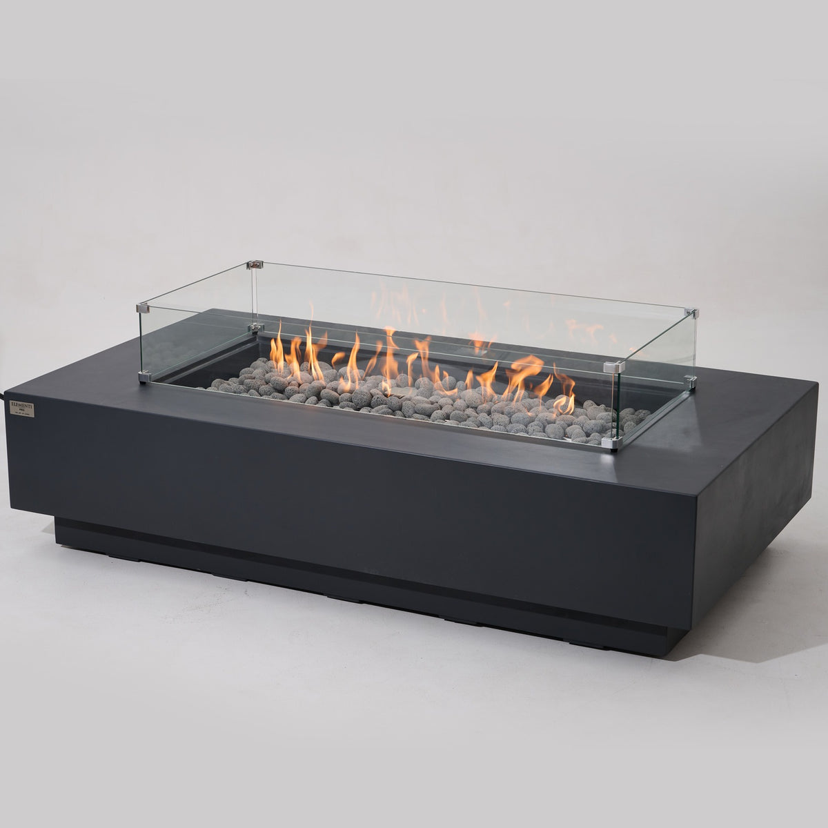 Elementi Pro Ravello 72-inch rectangle fire pit, Dark Gray – angled view with glass wind guard, lit