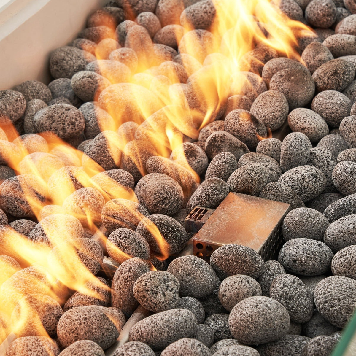 Elementi Pro Ravello 72-inch rectangle fire pit, Frosted Cream White – close-up of flames over lava rock