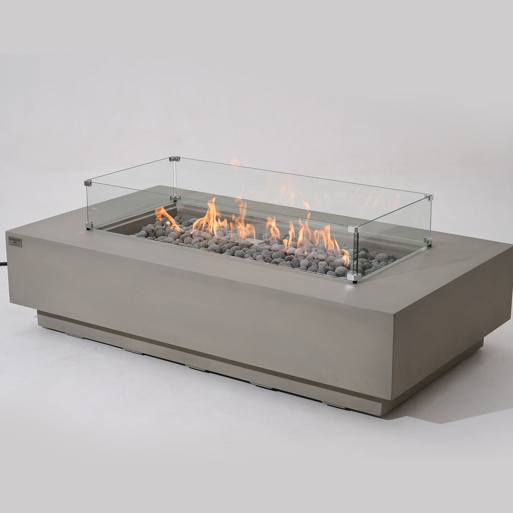 Elementi Pro Ravello 72-inch rectangle fire pit, Light Gray – angled view with glass wind guard, lit