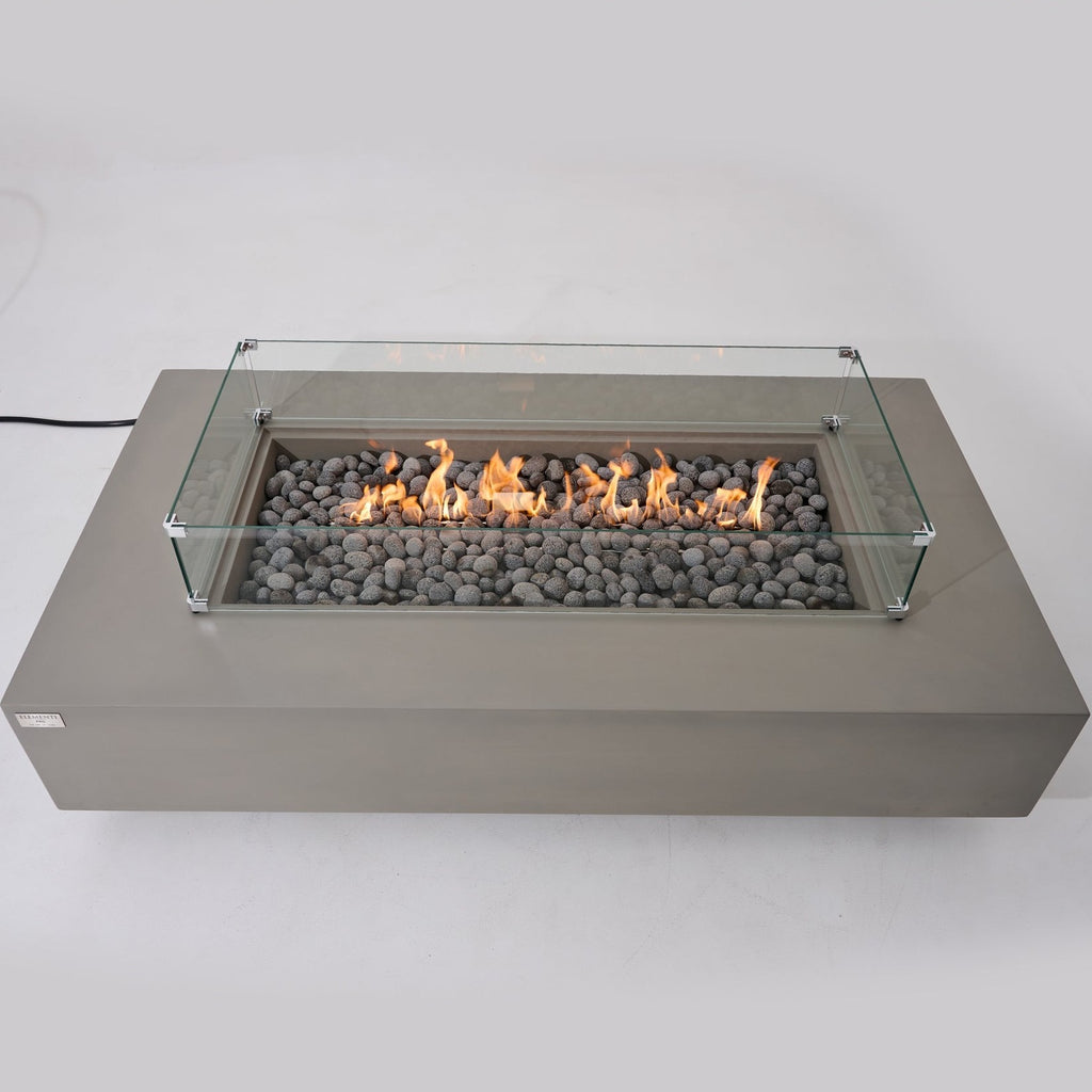 Elementi Pro Ravello 72-inch rectangle fire pit, Light Gray – front view with glass wind guard, lit