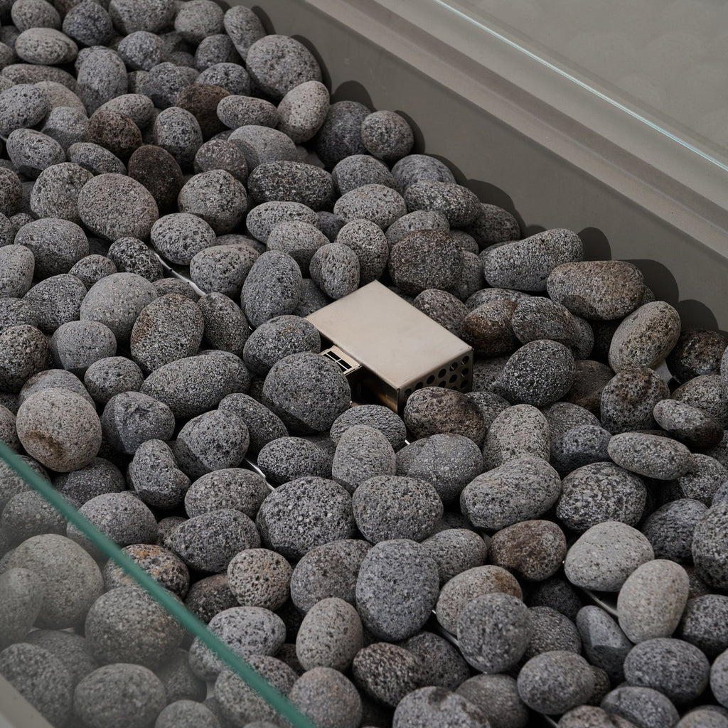 Elementi Pro Ravello 72-inch rectangle fire pit, Light Gray – burner and lava rock close-up