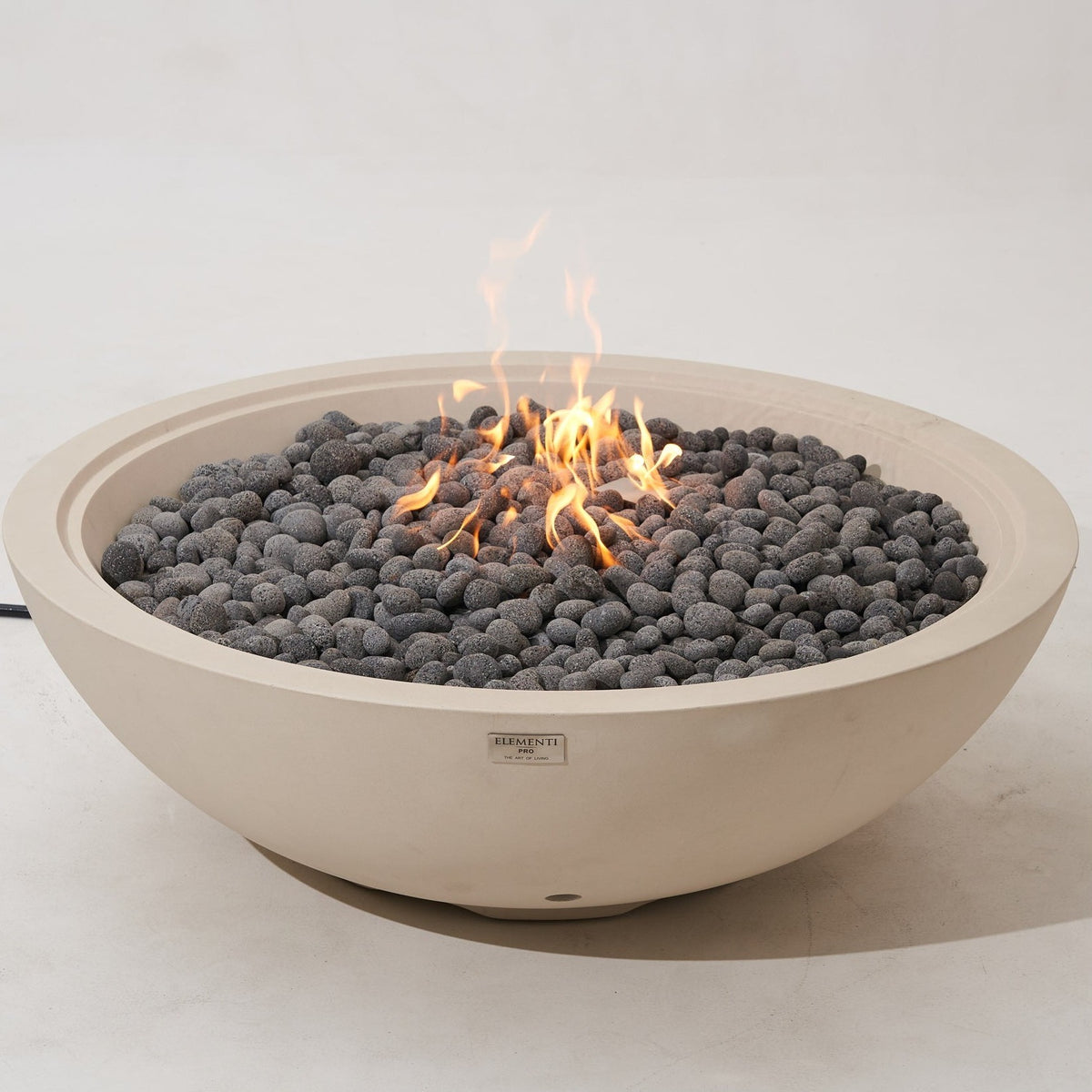 Elementi Pro Rose Bowl 48-inch 100K BTU fire pit, Frosted Cream White – angled view, lit