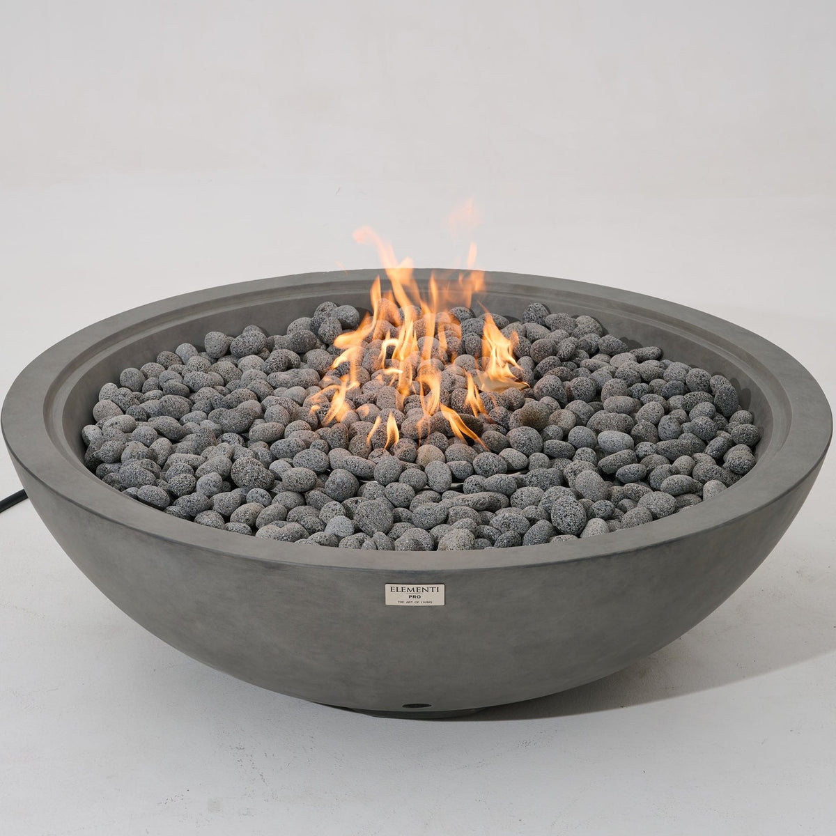 Elementi Pro Rose Bowl 48-inch 100K BTU fire pit, Moon Gray – angled view, lit