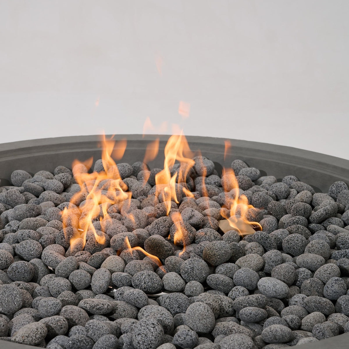 Elementi Pro Rose Bowl 48-inch 100K BTU fire pit, Moon Gray – close-up of flames over lava rock